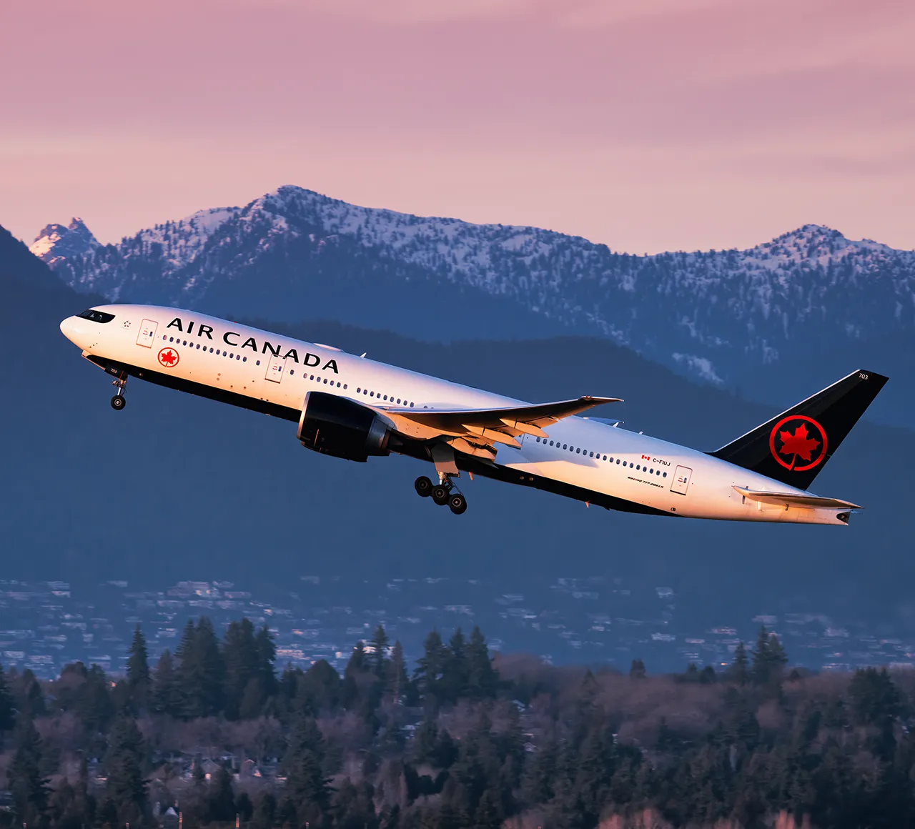 Air Canada Boeing 777 taking off from Vancouver International Airport during sunset