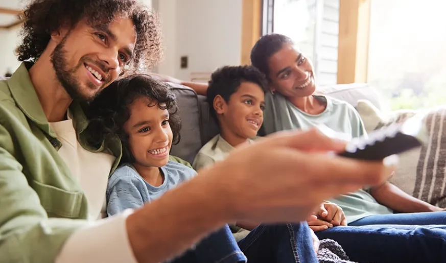 Father watching TV with sons
