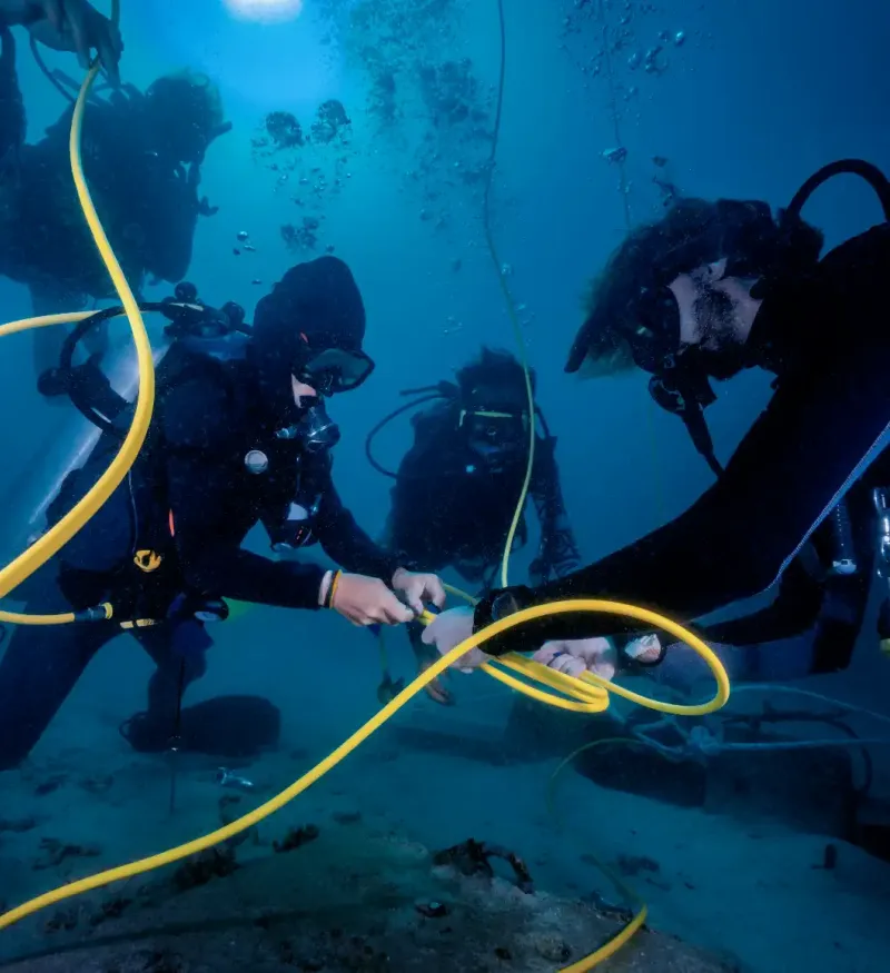 Scuba Divers Installing Calbe underwater