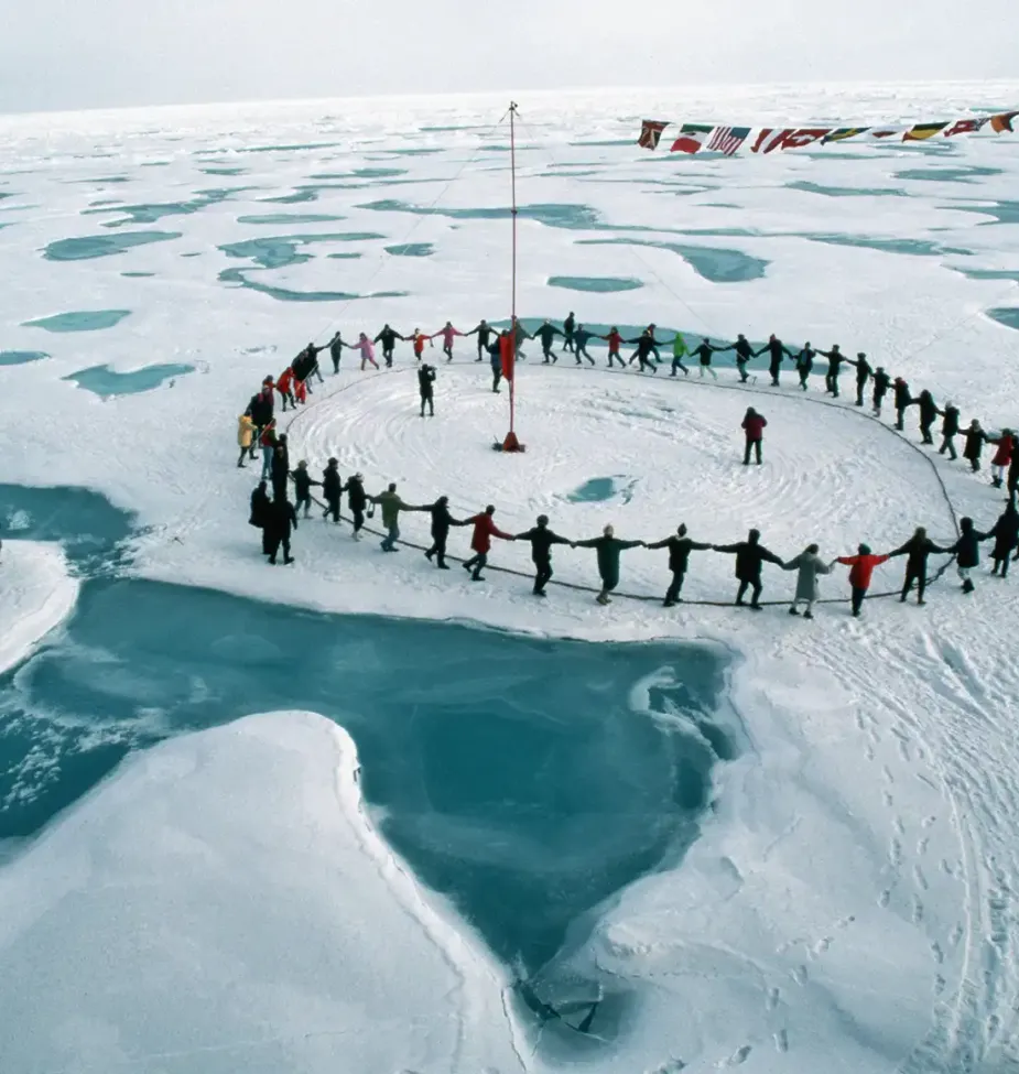 A group of tourists form a human circle and dance through all the time zones.