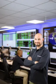 Team member standing in Eutelsat's Satellite Control Centre room of operations