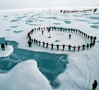 A group of tourists form a human circle and dance through all the time zones.