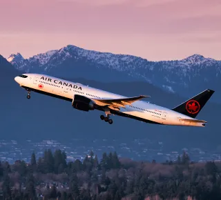 Air Canada Boeing 777 taking off from Vancouver International Airport during sunset