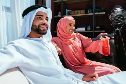 Image of couple in the Middle East watching tv 