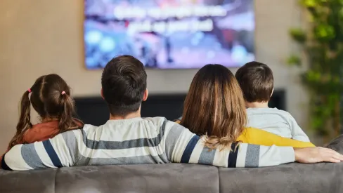 IMAGE_Press_Back-view-of-a-family-watching-tv-at-home_GettyImages_1392123667.webp