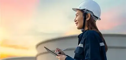 Person using a device outdoors at sunset